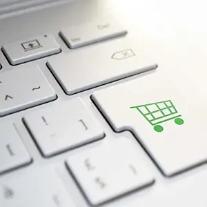 Zoomed In Shot Of A Computer Keyboard With A Shopping Cart Icon On The Return Key