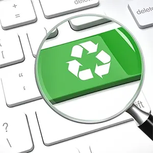Looking Through A Magnifying Glass At A Recycling Icon On A Computer Keyboard